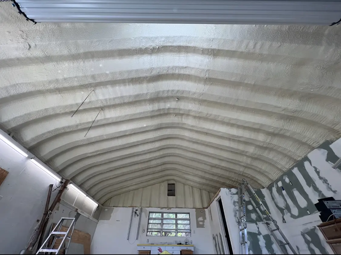 Spray polyurethane foam applied to the underside of a metal roof deck in Siesta Key